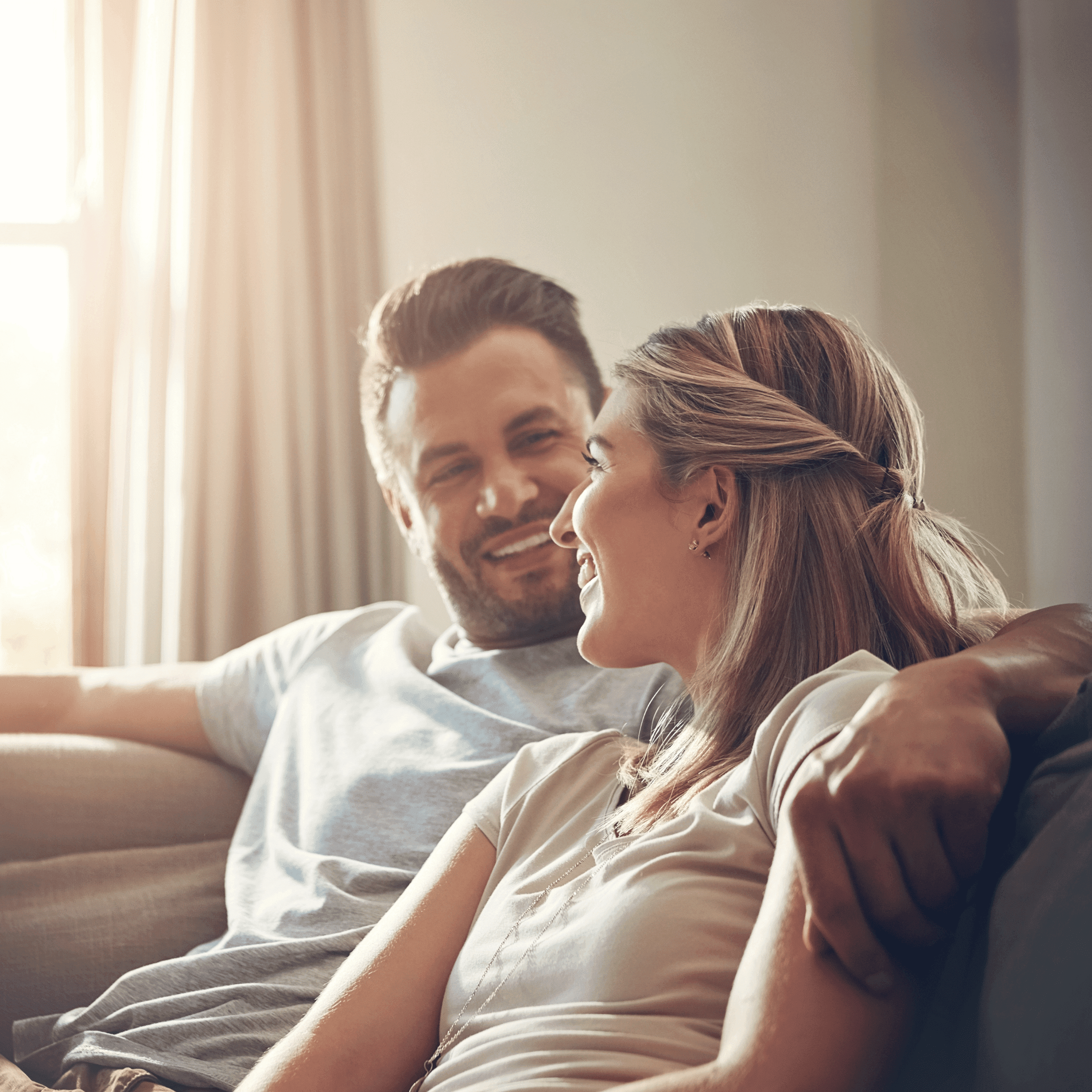 Couple smiling at each other, comfortably